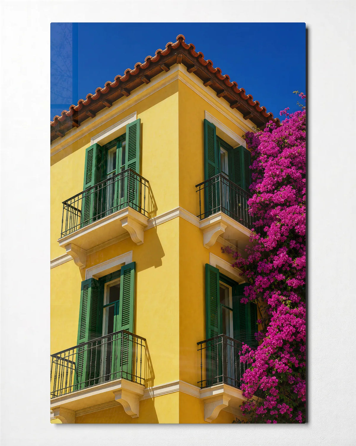 Yellow House Pink Flowers — front view of glass wall art