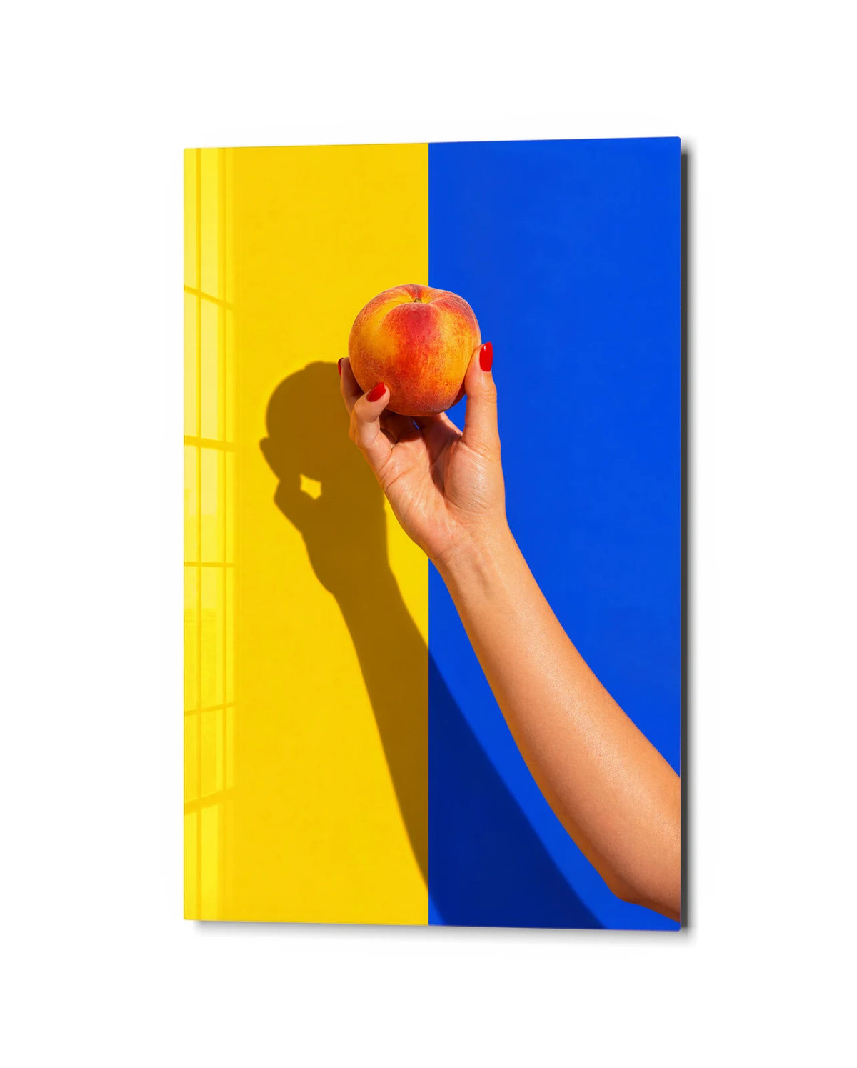 A Peach in Hand — studio view of glass wall art