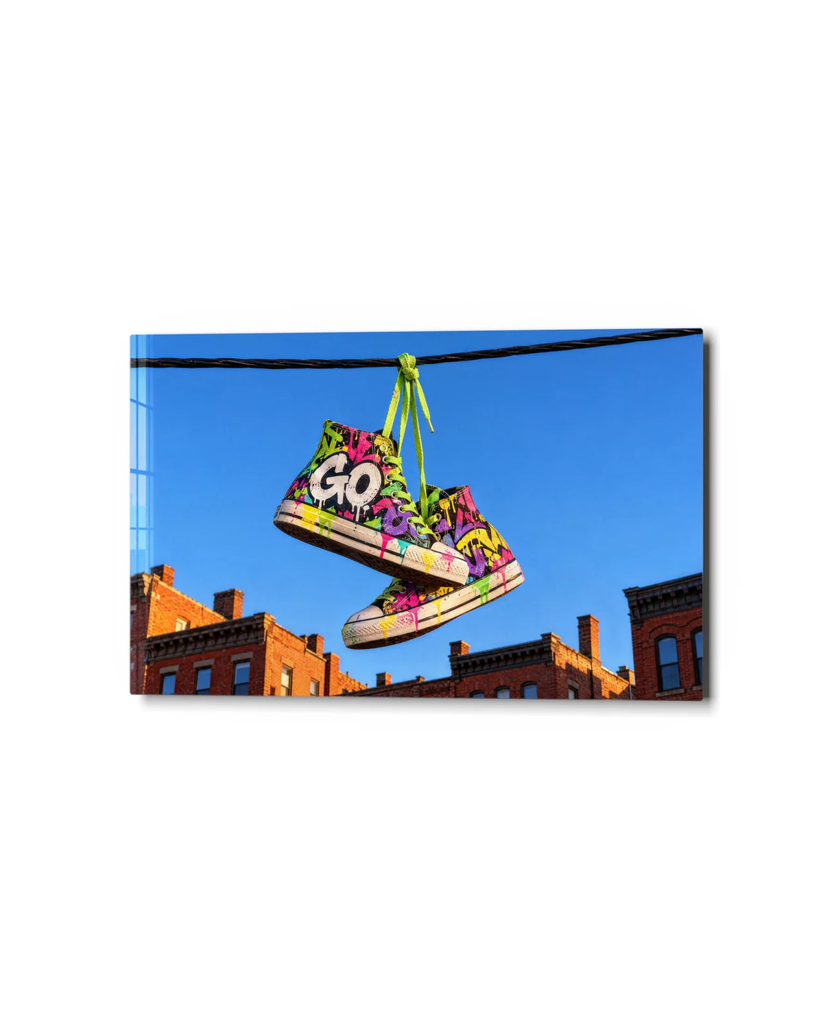 Sneakers on the Wire — studio view of glass wall art